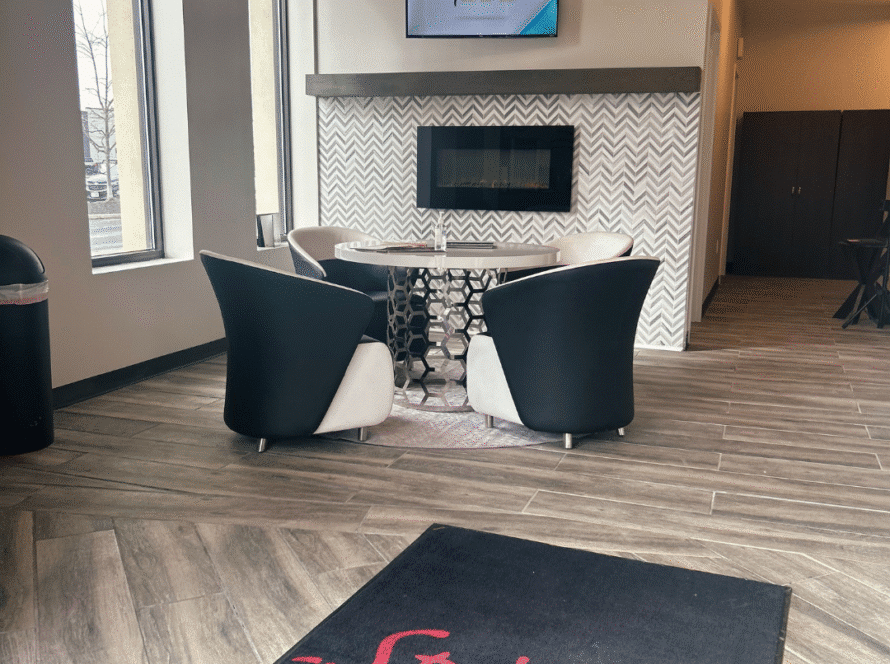 A welcoming interior view of Spitale Laser Spa Salon featuring elegant modern decor, cozy seating, and a branded entrance mat, reflecting the spa’s luxurious and professional atmosphere.